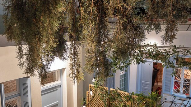 A modern outdoor area with a staircase, a wooden fence, and a bicycle. - Athenian Cypress House (Athina)