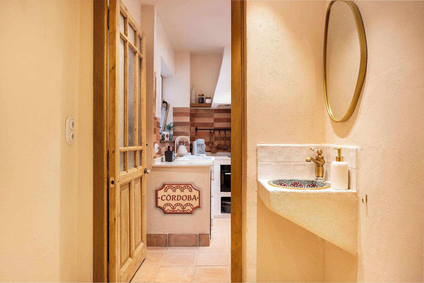 A hotel lobby with a wooden door, a reception desk, and a bathroom with a sink and toiletries.