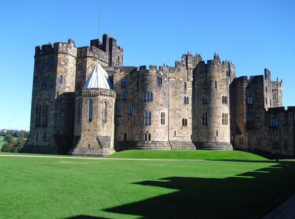 A large stone castle with multiple towers and a central courtyard.