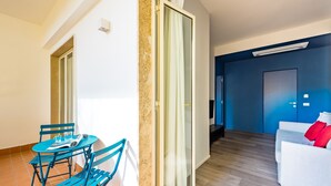 A modern living room with a white sofa and a blue accent wall. - Street Stritt 60 by Wonderful Italy - Apt 2 (Naples)