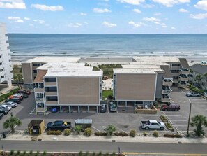 A multi-story parking structure with a view of the ocean.