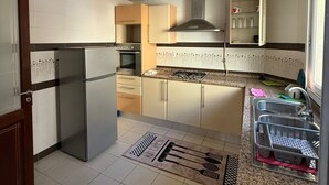 A modern kitchen with a central island, built-in oven, and stainless steel appliances. -  apartment in fabulous Tunis with AC, WiFi (Tunis)