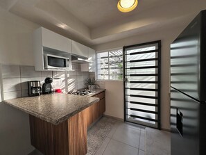 Fridge, microwave, stovetop, coffee/tea maker