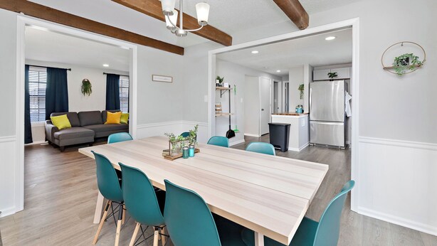 A modern interior with a dining area, kitchen, and living space. - Overland Park 4BR Home 2 Kings Garage Dog Friendly (Overland Park)