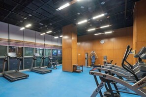 A gym with treadmills, stationary bikes, and weight machines.