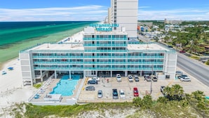A hotel with a pool, multiple floors, and a view of the beach. - Beachfront Studio, Sleeps 2, Pool (Panama City Beach)