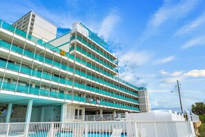 A multi-story hotel with a pool area and a sign indicating it is a 'COTTAGE BLEAU' hotel. - Beachfront Studio, Sleeps 2, Pool (Panama City Beach)