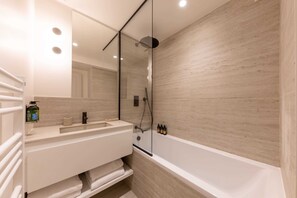 Shower, hair dryer, towels, shampoo