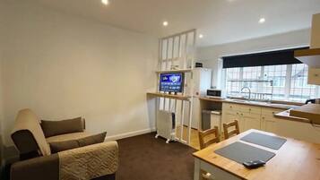 City Apartment | Living area | 32-inch Smart TV with satellite channels