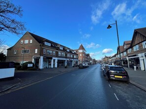 A street view with a row of brick buildings, some with shops on the ground floor. - Straight Inn (Sutton)