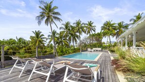 A wooden deck with white lounge chairs and a pool. - Villa 3 Anses - Three Bedroom Villa, Sleeps 8 (Sainte-Anne)