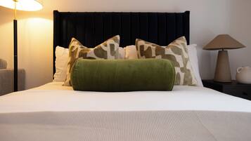 Desk, iron/ironing board, bed sheets