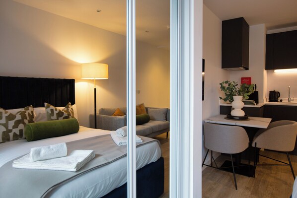 Desk, iron/ironing board, bed sheets