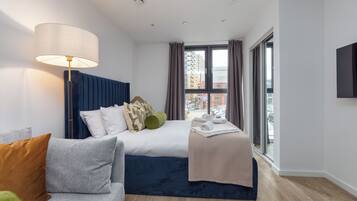 Desk, iron/ironing board, bed sheets