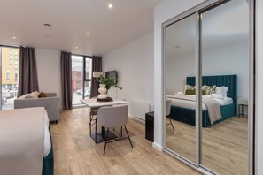 Desk, iron/ironing board, bed sheets