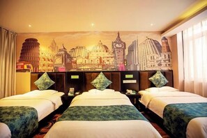 A hotel room with two beds, a cityscape mural on the wall, and a nightstand with a clock.