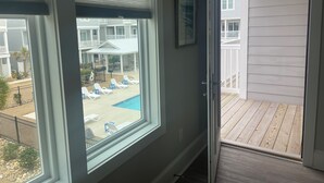 A room with a view of a pool and a deck. - Posh, New, Ocean View Townhome in gorgeous Emerald Isle Perfect for families (Emerald Isle)