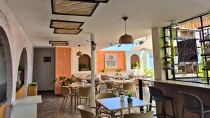 A restaurant with tables and chairs, a counter, and a sign for 'Terrazas del Sol Hotel'. - TERRAZAS DEL SOL (Arequipa)
