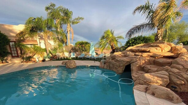 A pool area with lounge chairs, palm trees, and a rock formation. - LADIES SPA VILLA RETREAT - Cave Creek, AZ
Day Spa, Full Moon Drum Circle & Meals (Phoenix)