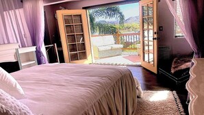 A bedroom with a large bed, a sliding glass door leading to a balcony, and a view of the outdoors. - LADIES SPA VILLA RETREAT - Cave Creek, AZ
Day Spa, Full Moon Drum Circle & Meals (Phoenix)