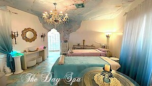 A spa room with a bed, a chandelier, a mirror, and a wall-mounted heater. - LADIES SPA VILLA RETREAT - Cave Creek, AZ
Day Spa, Full Moon Drum Circle & Meals (Phoenix)