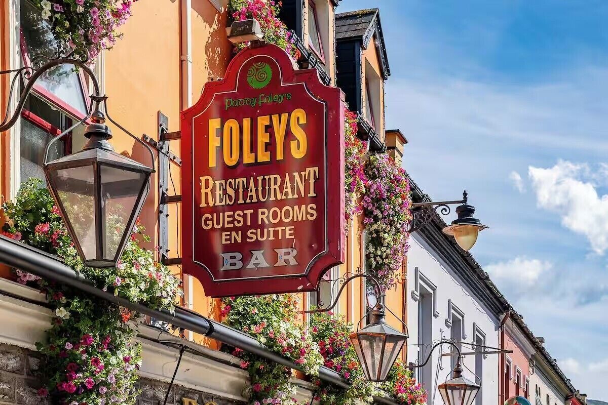 A sign for 'Foley's Restaurant' with 'Guest Rooms' and 'Bar' listed.