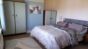 A bedroom with a bed, a nightstand, a wardrobe, and a wall-mounted picture. - House-sleeps 5-parking-bbq-garden-patio (Chesterfield)