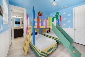A child's bedroom with a bunk bed, a ladder, and a play area with a slide. - Fantastic 6BR Themed Encore Home (Kissimmee)