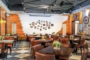 A restaurant interior with wooden walls, a checkered floor, and framed pictures on the wall. - Homeinn Superior Yun Hotel (Beijing Qianmen) (Beijing)