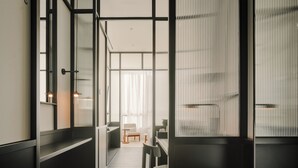 Un interno moderno con un corridoio stretto che porta a una zona salotto.