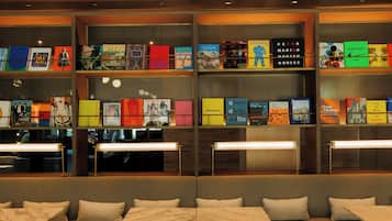 A library with bookshelves, seating, and tables.