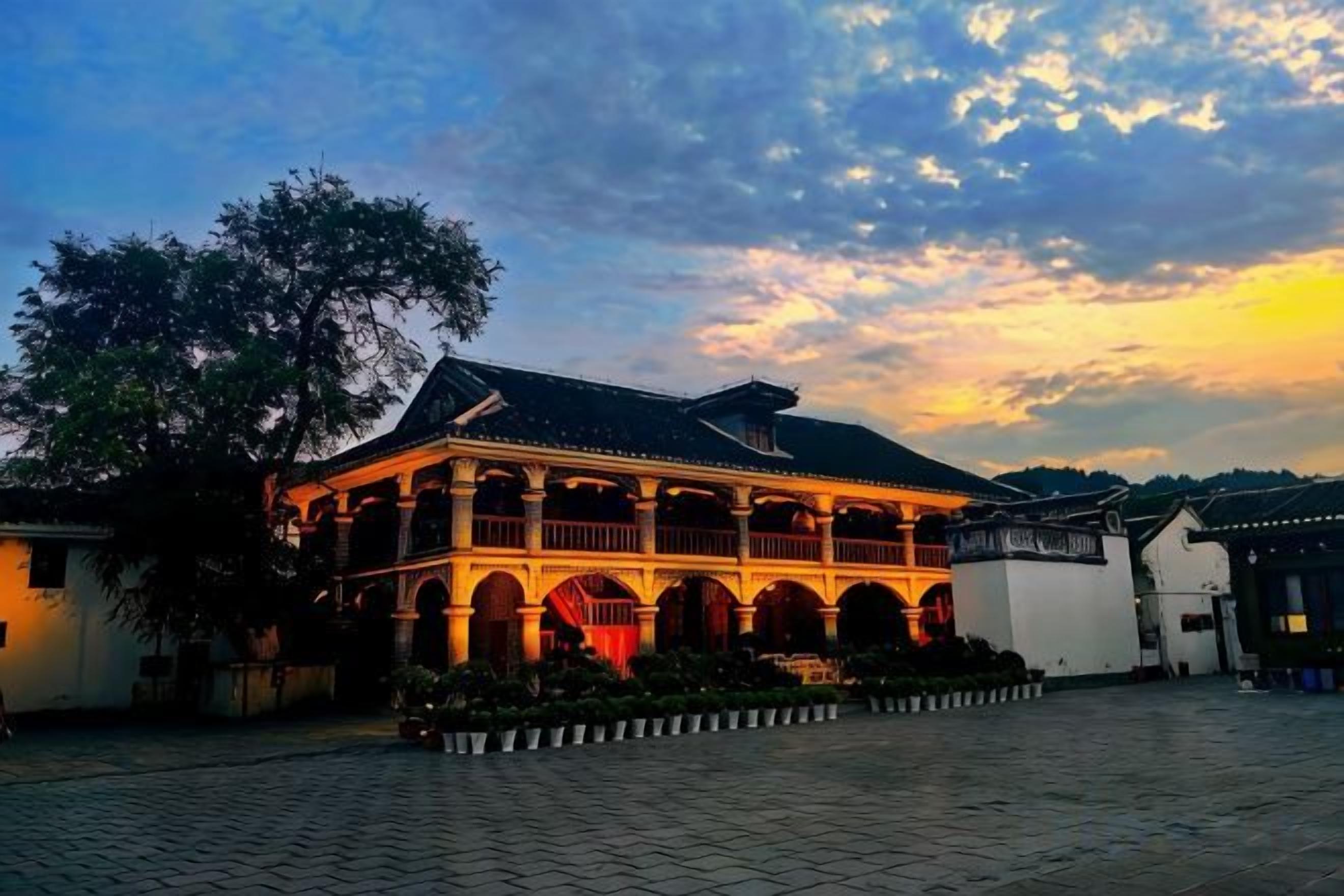 A traditional building with a covered walkway and a courtyard.