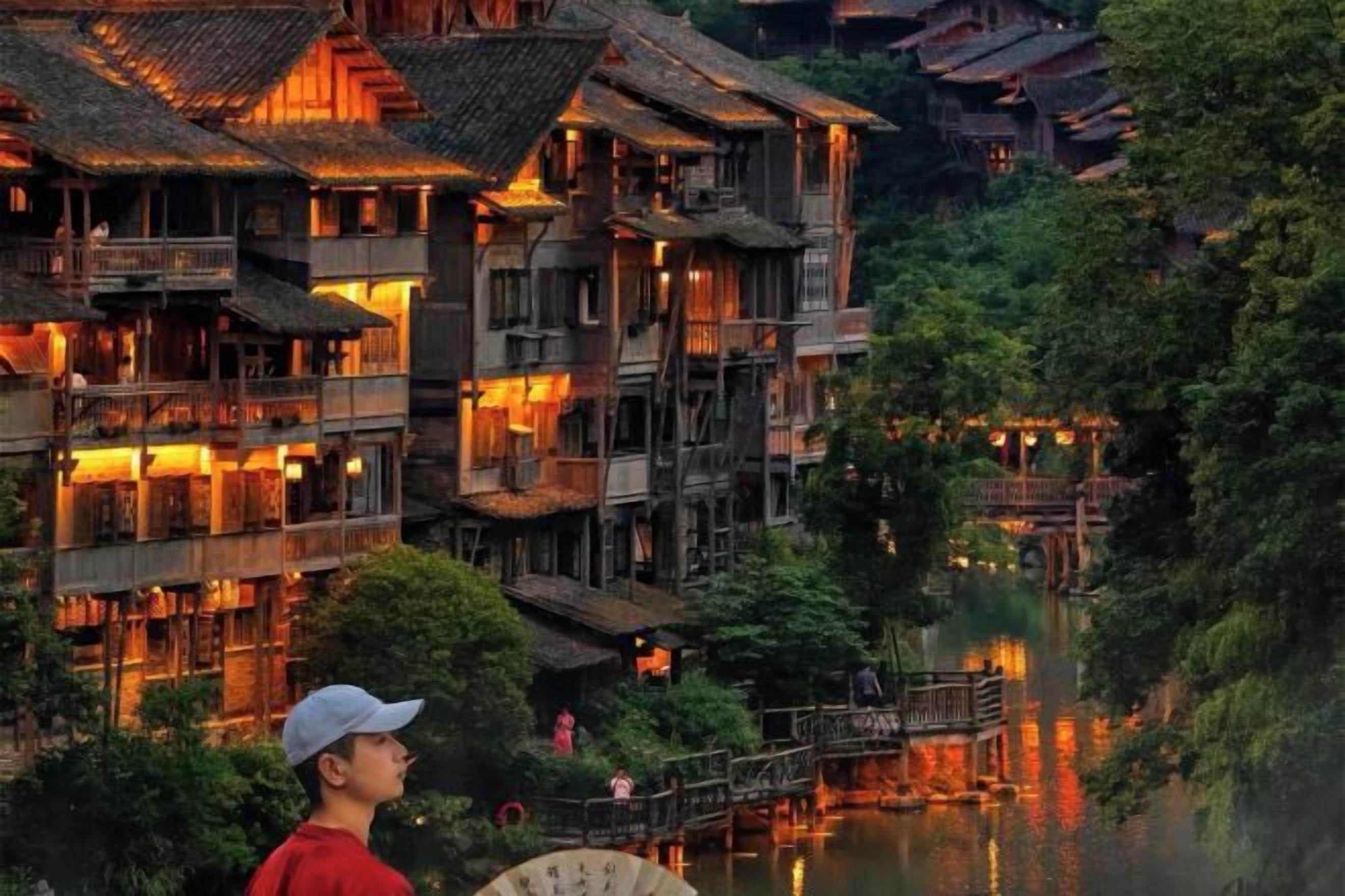 A traditional multi-story building with balconies, a wooden bridge, and a river.
