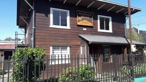 A two-story building with a sign reading "HOSPEDAJE IRMA." - Hostal Irma (Pucon)