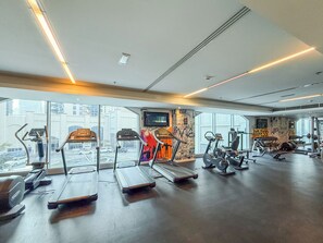 A gym with treadmills, elliptical machines, and weight equipment.