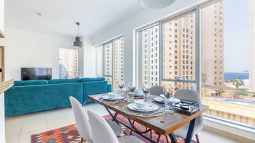 Comfort Apartment, 1 Bedroom, Balcony, City View | Living area | 50-inch Smart TV with digital channels