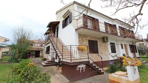 A two-story house with a balcony, a staircase, and a garden area. - ROSANNA 2 Studio with Balcony (Rovinj)