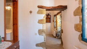 A narrow hallway with stone walls and a wooden door frame. - Traditional Cretan House (Faistos)