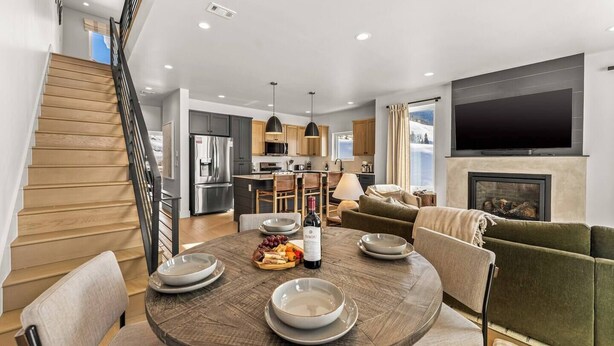 A modern living space with a dining area, kitchen, and a fireplace. - 4 BR Cozy Upscale Mountain Retreat, Hot Tub, Mountain Views (Crested Butte)