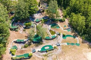 An aerial view of a golf course with multiple green areas and pathways. - Cabin 2340 - Comfortable Log Cabin within Private Resort (Bagley Township)