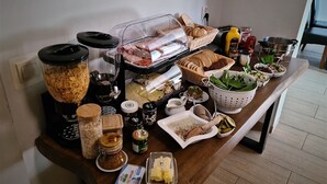 A buffet table with various food items, including bread, cheese, and condiments. - Lipowe Wzgórze (Limanowa)