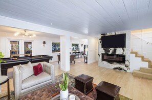 TV connectée, cheminée, livres, chaîne hi-fi