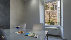 A modern dining area with a table, chairs, a martini glass, and a map.