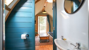 A bathroom with a sink, toilet, and a mirror. - Deluxe Cosy Cabin in the Scottish Highlands (Tomintoul)