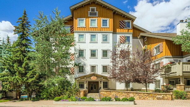 A multi-story hotel with a traditional architectural style, featuring a stone facade and a wooden upper section. - Enjoy this Intimate 1-Bedroom Retreat in the Heart of Vail (Vail)