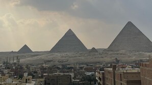 A view of the pyramids with a cityscape in the foreground. - Bastet Pyramids View Inn (Giza)