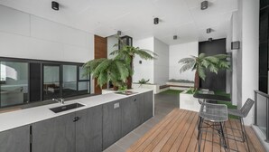A modern kitchen with a large island, built-in appliances, and a bar area with seating.