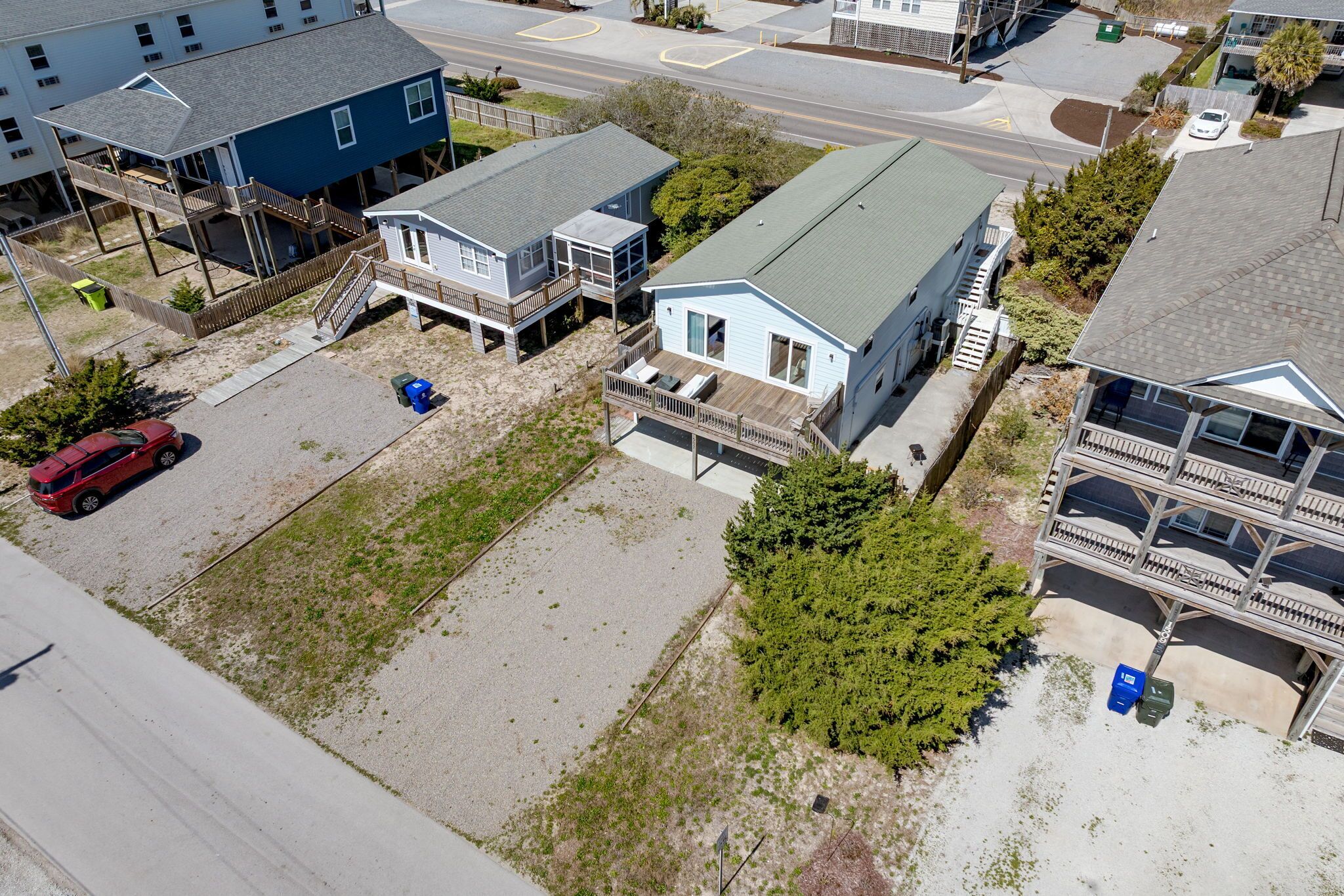 A residential area with a house featuring a covered porch and a garage.