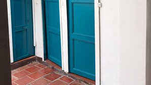 A set of three doors with a sign above them reading "Baño Mixto". - The Best Adventure (San Gil)