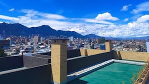 A rooftop pool with a cityscape and mountains in the background. - Apartment in the cultural center of Bogota (Bogotá)